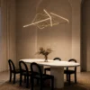 Ailish gold geometric LED chandelier above a contemporary dining table