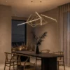Ailish gold geometric LED chandelier illuminating a modern dining interior