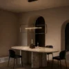 Alethea matte black geometric chandelier above a contemporary dining table