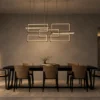 Alethea geometric LED chandelier above a contemporary dining table
