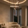 Athos sculptural LED chandelier creating a statement above a modern living room