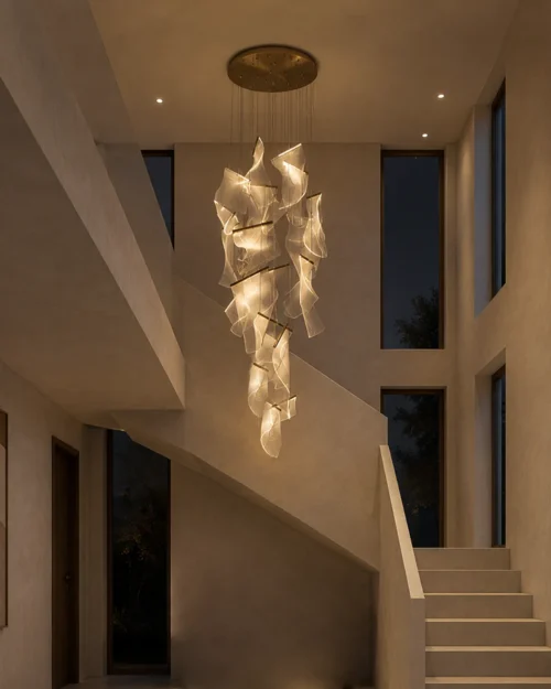 Auretta gold sculptural LED chandelier illuminating a modern stairwell