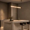 Bahari Bronze Gold linear chandelier illuminating a modern kitchen island