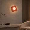 Calissa Coral Red sculptural wall lamp providing warm illumination in a modern interior