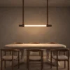 Clio linear chandelier illuminating a contemporary dining room