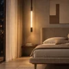 Clio Vertical brown and pearl black chandelier providing warm illumination beside a modern bedroom