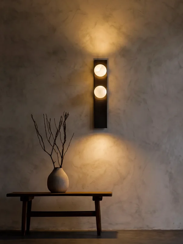Double Sphere dark brown wall lamp illuminating a modern interior