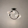 Hebe modern ceiling light with clear glass globes and sculptural iron frame