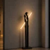 Humano Couple sculptural floor lamp illuminating a contemporary interior