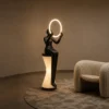 Humano Mirror sculptural floor lamp with illuminated circular light in a modern interior