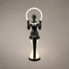 Humano Mirror matte black sculptural floor lamp with illuminated circular light