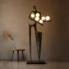 Humano Musician sculptural floor lamp illuminating a modern interior