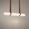 Ianthe dark brown linear chandelier with suspended straps and illuminated detailing