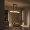 Ianthe dark brown linear chandelier illuminating a modern interior