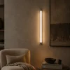 Keaton Gun Black linear wall lamp illuminating a contemporary interior