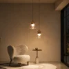Lara brass gold pendant light with layered circular shade and clear glass element