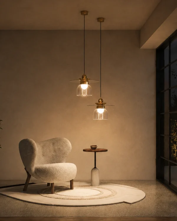 Lara brass gold pendant light with layered circular shade and clear glass element