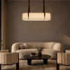 Nereus modern linear chandelier illuminating a contemporary living room