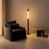 Safiya black minimalist floor lamp providing warm ambient lighting in a modern interior