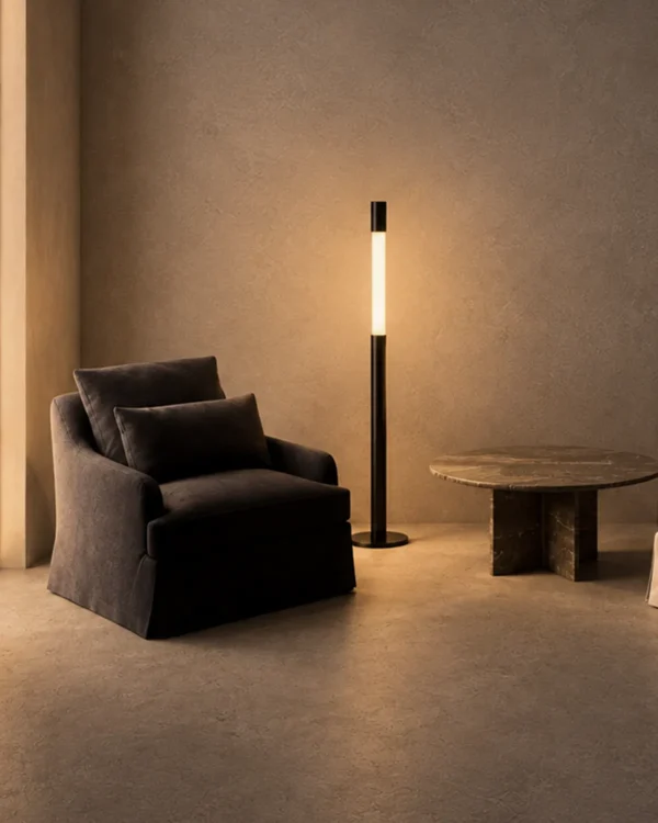 Safiya black minimalist floor lamp providing warm ambient lighting in a modern interior