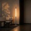 Safiya grey minimalist floor lamp illuminating a contemporary interior