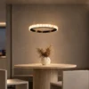 Soma dark brown circular chandelier above a contemporary dining table