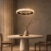 Soma modern ring chandelier illuminating a contemporary dining room
