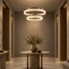 Valor Duo coffee gold double-ring chandelier illuminating a contemporary interior