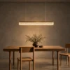 Valor Hanging linear chandelier above a modern dining table