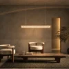 Valor Hanging coffee gold linear chandelier illuminating a contemporary interior