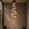 Valor Staircase multi-ring chandelier illuminating a contemporary high-ceiling interior