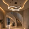Valor Trio coffee gold three-ring chandelier illuminating a contemporary interior