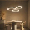 Valor Trio multi-ring chandelier above a modern dining table