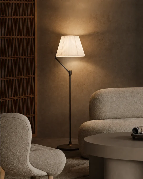 Vansa brushed bronze floor lamp illuminating a modern living room