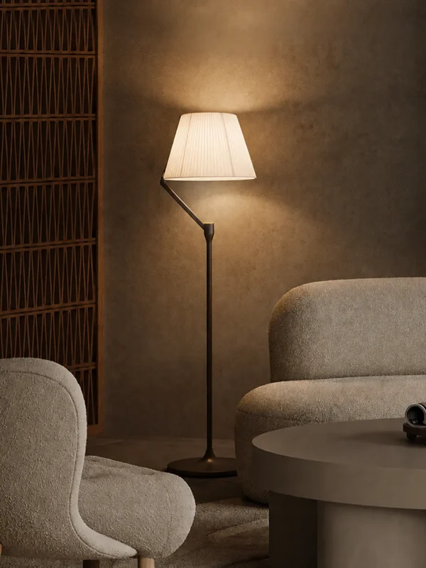 Vansa brushed bronze floor lamp illuminating a modern living room