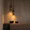 Abramo Pendant Lights Modern Interior Two Abramo cylindrical pendant lights suspended at different heights above a contemporary seating area