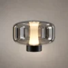 Adina Smokey Grey table lamp with rounded glass body and illuminated center