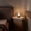 Adina table lamp displayed beside a bed in a contemporary interior