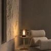 Adina table lamp displayed beside a lounge chair in a modern living room