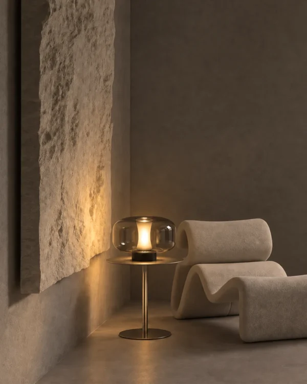 Adina table lamp displayed beside a lounge chair in a modern living room