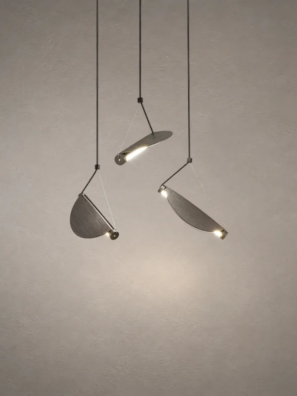 Aion Sculptural Pendant Light Aion pendant light featuring three angled cylindrical shades in Rustic Coffee and White
