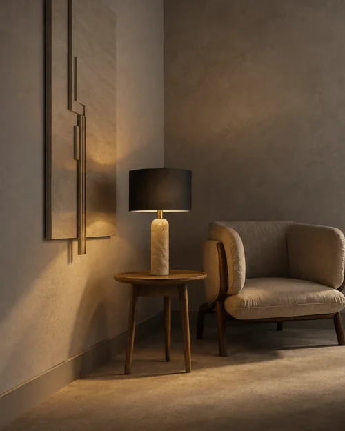 Albora Table Lamp Black Shade Albora table lamp with a black cylindrical shade and textured light-colored base beside an upholstered chair