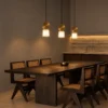 Alessandra Pendant Light Dining Room Three Alessandra gold and marble pendant lights suspended above a contemporary wooden dining table
