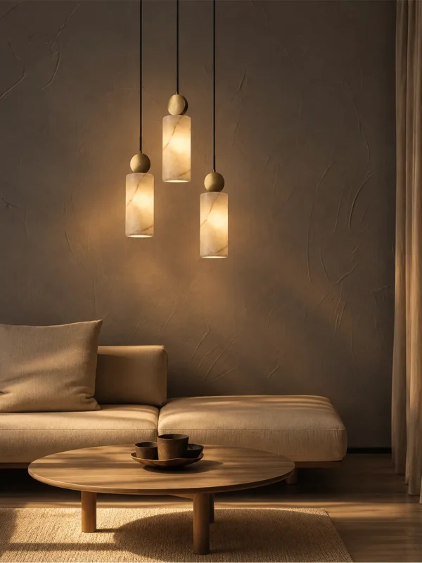 Three Alexandra marble pendant lights arranged at different heights in a modern living room