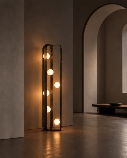Alister brushed black floor lamp featuring six illuminated glass spheres beside an arched doorway