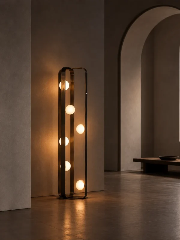 Alister brushed black floor lamp featuring six illuminated glass spheres beside an arched doorway
