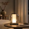 Alvero Smokey Grey table lamp with illuminated cylindrical center in a contemporary interior
