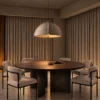 Amana grey dome pendant light suspended above a round wooden dining table
