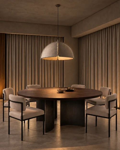 Amana grey dome pendant light suspended above a round wooden dining table