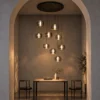 Aspen 9 Round Chandelier with suspended Smokey Grey glass pendants above a dining area